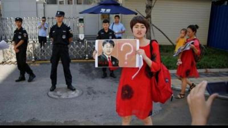 Wife of detained Chinese activist and 3 supporters go bald, protest for justice.