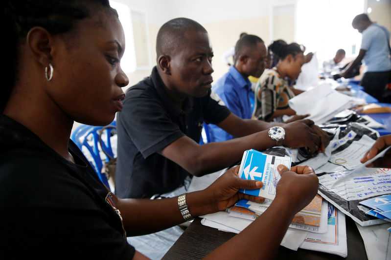 Officials from Congo's Independent National Electoral Commission count presidential elections ballots at tallying centre in Kinshasa