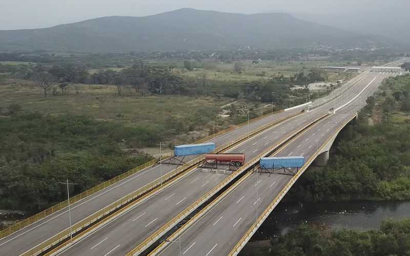 Venezuela military barricades bridge in attempt to block aid