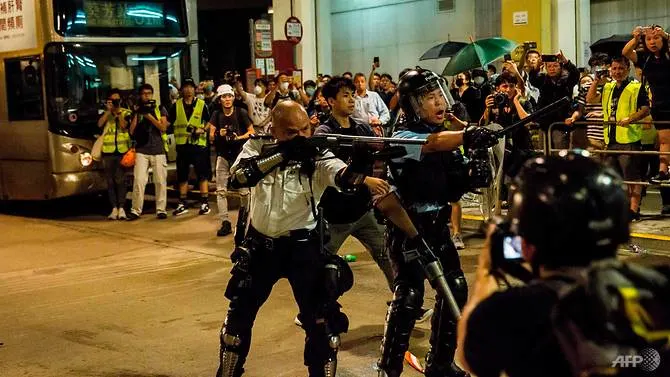 Clashes between officers and protesters outside Hong Kong police station