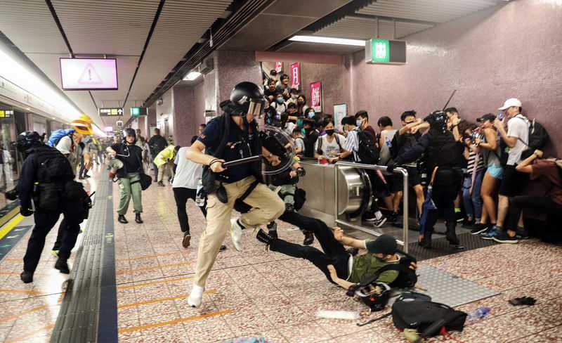 Hong Kong police storm subway with batons as protests rage