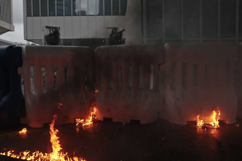 Hong Kong protesters build wall on main street, set it on fire