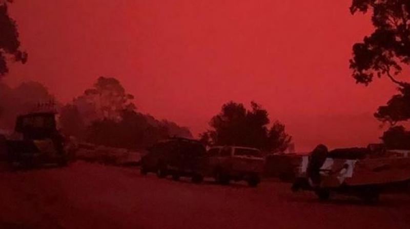 ‘Blood-red sky, choking dust’: Thousands trapped on Australia beaches by wildfires
