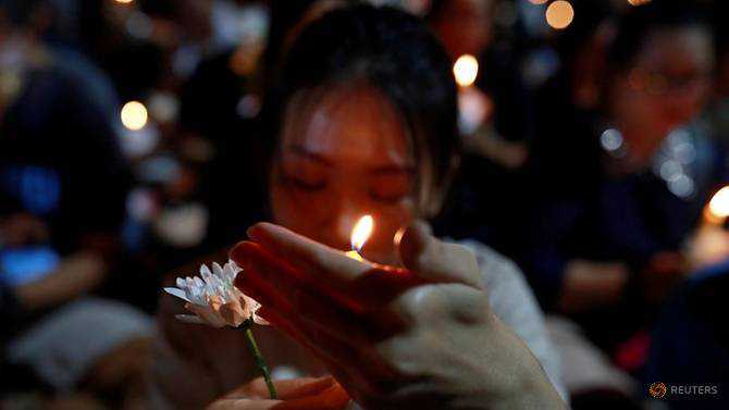 Thousands light candles for victims of Thailand mass shooting