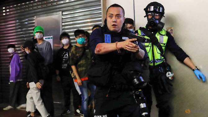 Hong Kong police fire tear gas as black-clad protesters go back to streets