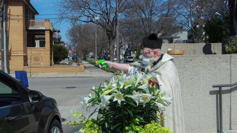 Michigan priest draws squirt gun to shoot holy water