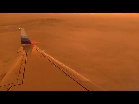 Alaskan Airlines plane flies through blood orange skies on California