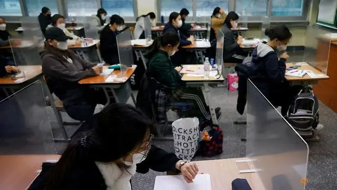 South Korea students sit school examination behind plastic barriers and in hospitals because of COVID-19