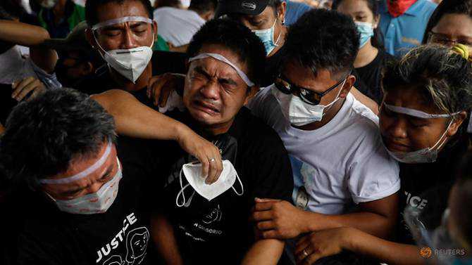 Filipino mother and son shot dead by policeman laid to rest