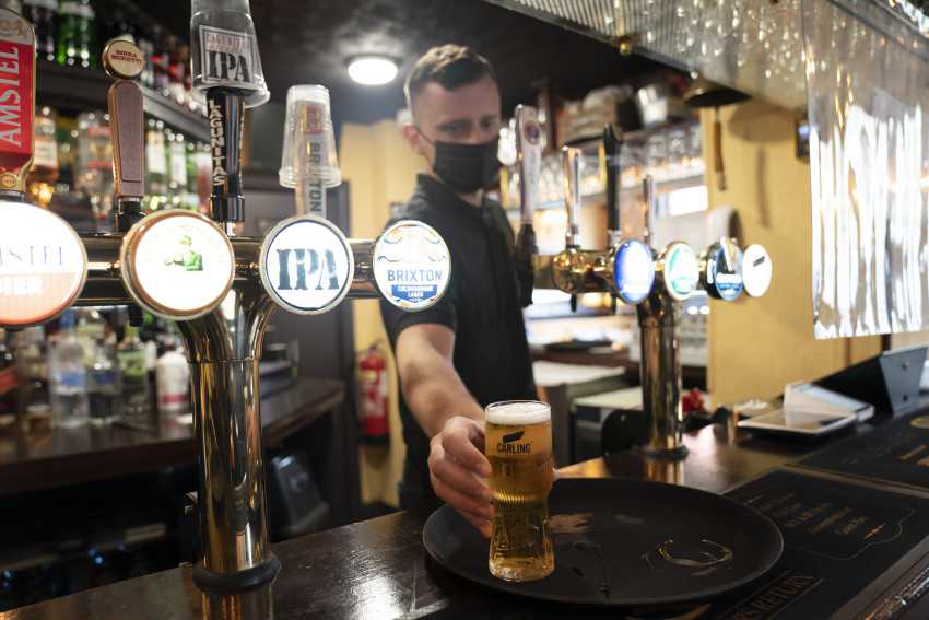 Joy for reopening of UK pubs and hugs tempered by rise in virus variant