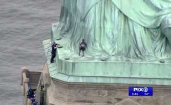 Woman climbs Statue of Liberty to protest Trump’s immigration policy