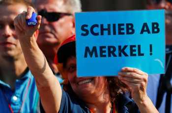 Merkel vows action over asylum seekers