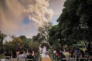 Smoke show: Taal volcano eruption takes centre stage in Philippines couple's wedding photos